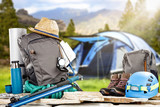 Fototapeta  - Backpack on stones and blurred blue tent.Spring trip time. 
