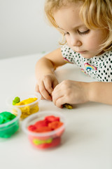 Wall Mural - the child is engaged in modeling on the table