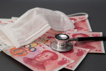 Chinese paper currency with face mask and stethoscope 