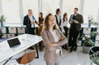 © F8  \ Suport Ukraine - Female Business leader standing in front of her team in office