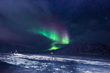 Wall Mural - the polar arctic northern lights hunting aurora borealis sky star in norway travel photographer man 