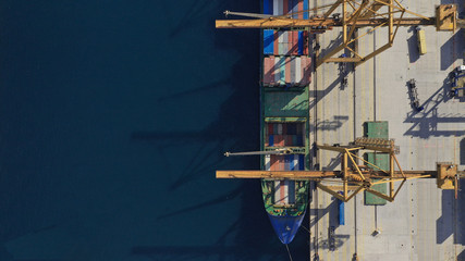 Aerial drone top down photo of industrial container logistics loading - unloading ship terminal in Mediterranean destination port