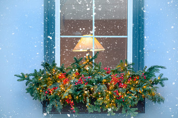 Wall Mural - Winter Window with Lamp and Garlands exterior of an old House during Snowfall