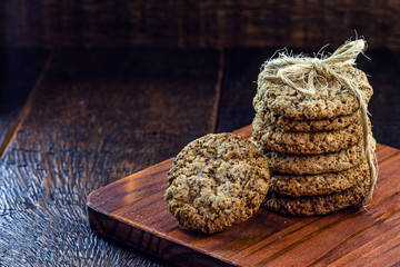 wholemeal biscuit made in a wing, stacked on a rustic wooden background.