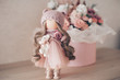 decorative doll in the room on a background of flowers