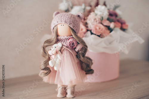 decorative doll in the room on a background of flowers Poster Mural XXL