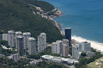 High rise luxury apartment buildings in the São Conrado neighbourhood with the beach and coastal road in the background in Rio de Janeiro, Brazil