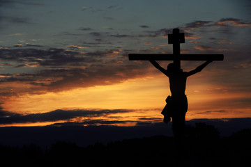 Poster - Silhouette of Jesus with Cross over sunset sky