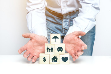 Poster - Insurance symbols on wooden blocks. Insurance and security concept. Health, life and valuable items insurance. Securing the family and house.