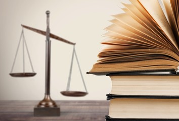 Poster - Law scales and books on wooden table. Symbol of justice