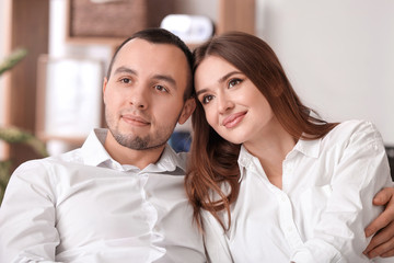 Sticker - Beautiful young couple watching TV at home