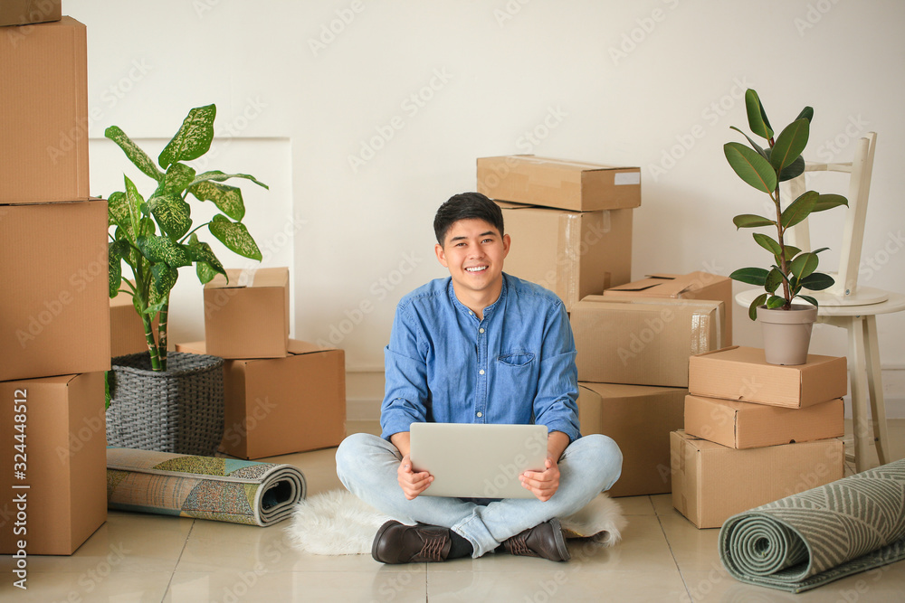 Asian man with laptop planning design of new flat