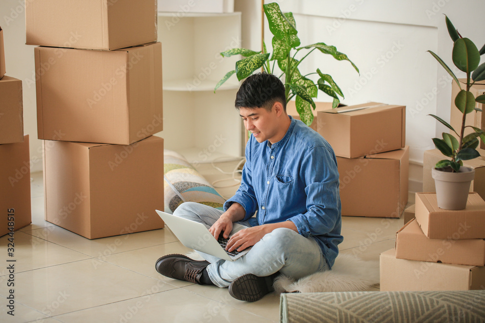 Asian man with laptop planning design of new flat