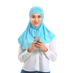 Poster - Young Arab woman with mobile phone on white background