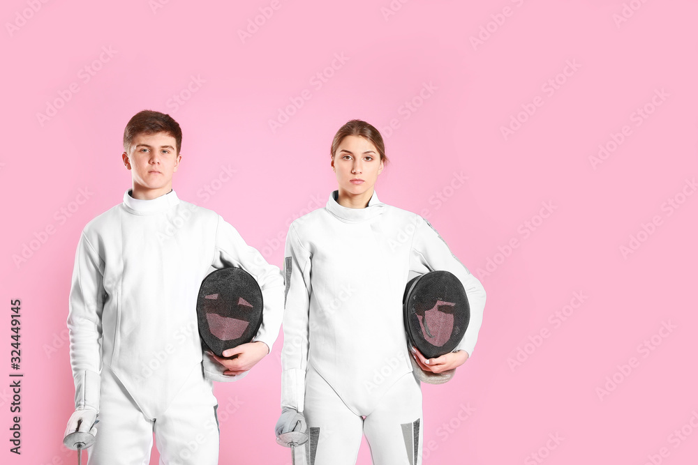 Young fencers on color background