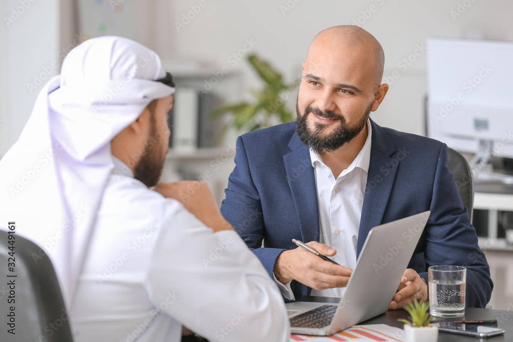 Arab man and his business partner in office