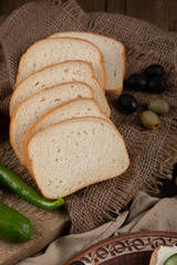 Finely sliced white bread in rustic background.