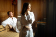 Beautiful couple relaxing in sauna and caring about health and skin