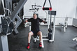 © amixstudio - Adult gray-haired man trains on fitness equipment in the gym, pumps legs and arms muscles, loses weight. Concept of healthy lifestyle in old age
