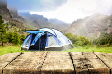 Desk of free space and blurred landscape of camping 