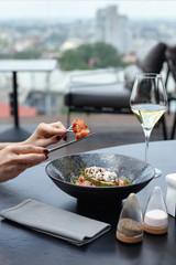 exquisite restaurant dish on a flat plate on a colored background. Restaurant serving. View from above