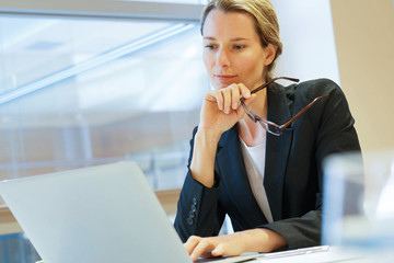 Wall Mural - Businesswoman modern office working on laptop computer