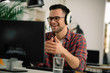 © JustLife - Businessman on video call. Handsome man in office with headphones.