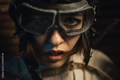 Fotomural Mad Woman In A Straitjacket And A Pilot Helmet With Glasses