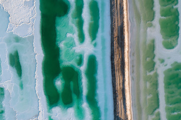 Wall Mural - aerial view of a gravel road and salt lake