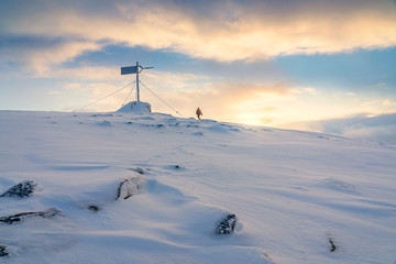 nice senior woman snowshoeing in the arctic landscaoe of northern norway near the city of tromso