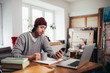 © cherryandbees - young man freelancer working from his home