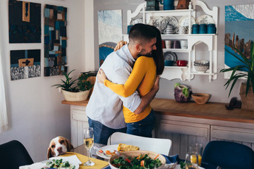 family hugging , dinner party at home