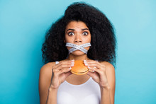 Close-up Portrait Of Nice Attractive Scared Wavy-haired Girl Holding In Hand Burger Restriction Mouth Crossed Closed By Centimeter Line Isolated On Bright Vivid Shine Vibrant Blue Color Background