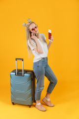 Hipster traveler woman talking on mobile connection roaming - happy young woman with travel baggage calling on smartphone