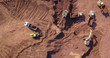 © MagioreStockStudio - Excavators loading soil onto an Articulated hauler Trucks. Aerial image.