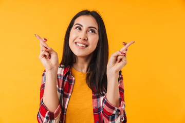 Poster - Photo of dreaming young woman smiling with fingers crossed