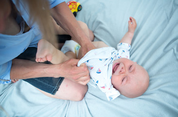 Cute baby with mother at home