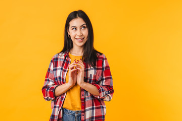 Wall Mural - Photo of pleased brunette woman smiling while looking aside