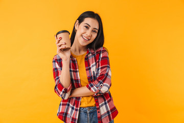 Wall Mural - Photo of happy young woman smiling and drinking coffee takeaway