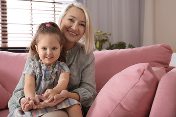 Wall Mural - Happy granddaughter and grandmother together at home