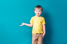 Little Boy On Blue Background, Surprised Show Fingers Near Space With Him.