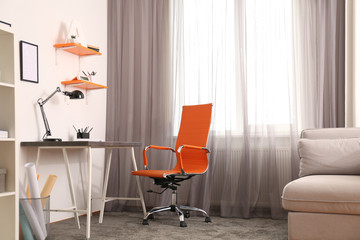 Wall Mural - Stylish room interior with comfortable workplace near window. Design idea