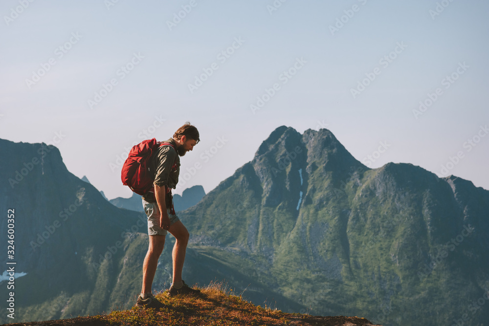 Man hiking in mountains travel backpacking summer vacations outdoor adventure trekking active healthy lifestyle in Norway - obrazy, fototapety, plakaty 