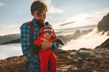 Wall Mural - Cute baby with father traveling in mountains family tourism vacations together active healthy lifestyle man with child hiking outdoor