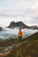 woman standing alone in mountains travel adventure lifestyle outdoor in norway hiking activity recre