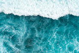 Fototapeta Do pokoju - Texture Light blue surface of raging sea water with white foam and wave pattern