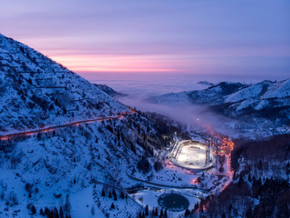 View of the Medeo ice rink late at night. Winter in the mountains of Zailiysky Alatau. Small Almaty Gorge. Late evening in the mountains