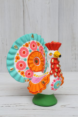 Wall Mural - Ancient russian traditional national folk handcraft, handicraft - old dymkovo clay toy (doll): colorful turkey-cock or rooster. Best souvenir from Russia. Folk art in russian style. National culture