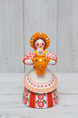 Wall Mural - Ancient russian traditional national handcraft, handicraft - old dymkovo clay toy (doll): woman in russian folk style with samovar for tea drinking and kokoshnik. Best souvenir from Russia. Folk art