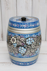 Ancient russian traditional national handcraft: keg with blue north khokhloma painting with berries. Beautiful vintage wooden ware on white background. Best souvenir from Russia. Russian folk style